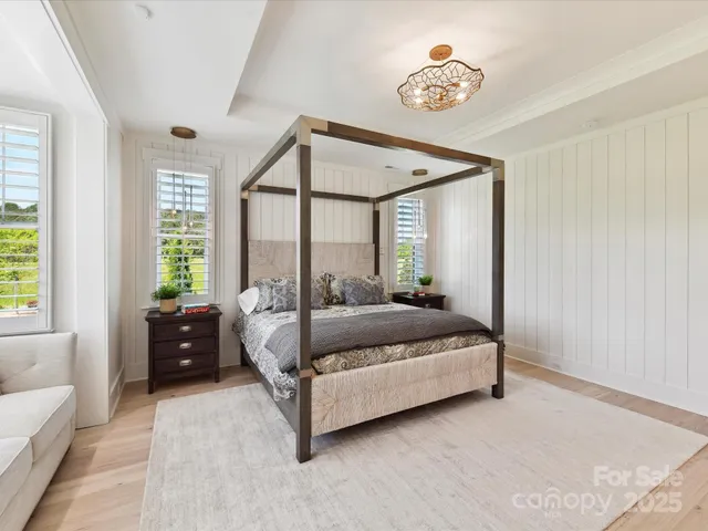 a bed room with a bed and a large window