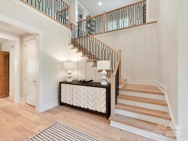 a view of entryway bedroom and hall with wooden floor