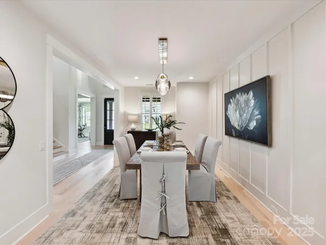 a dining room with furniture a rug and a chandelier