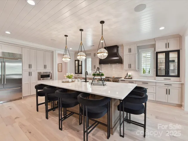 a kitchen with a sink and chairs
