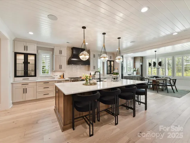 a large kitchen with lots of counter space and furniture
