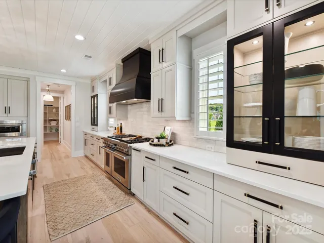 a kitchen with stainless steel appliances granite countertop a stove and a sink