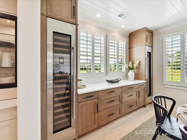 a kitchen with stainless steel appliances granite countertop a stove a sink and a refrigerator with wooden floor