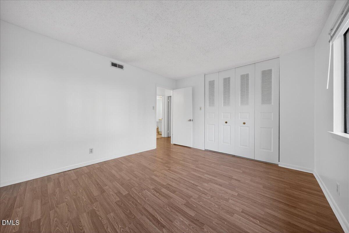 3088 Colony Road, Unit 3088D Durham, NC 27705 - Photo 20 of 25 a view of an empty room with wooden floor