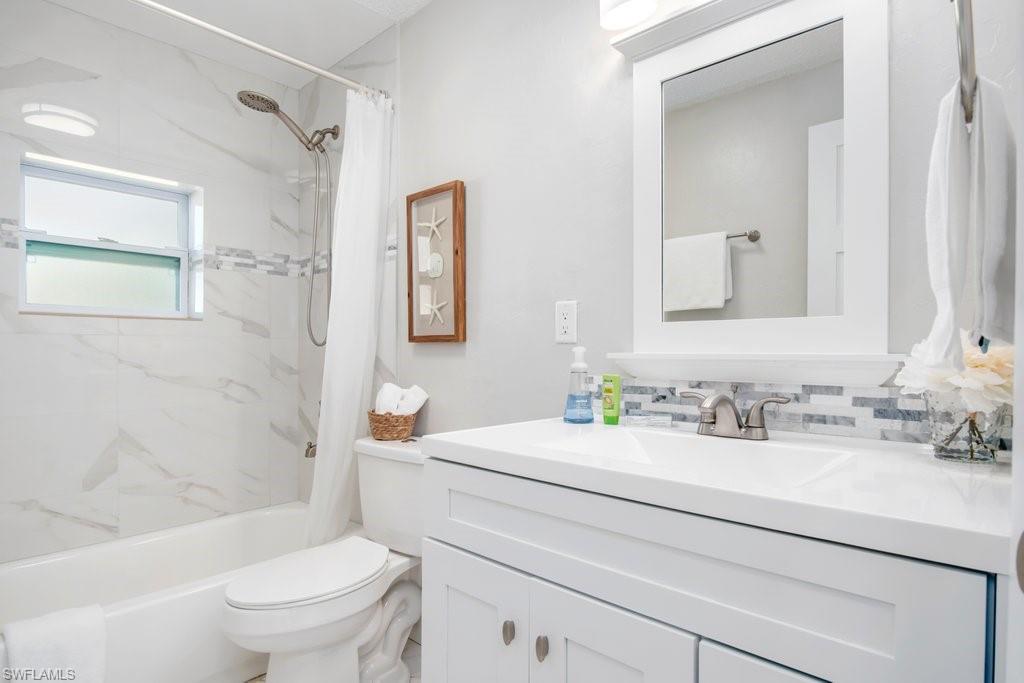 1207 Hernando Street Naples, FL 34103 - Photo 24 of 37 a bathroom with a sink toilet vanity and shower