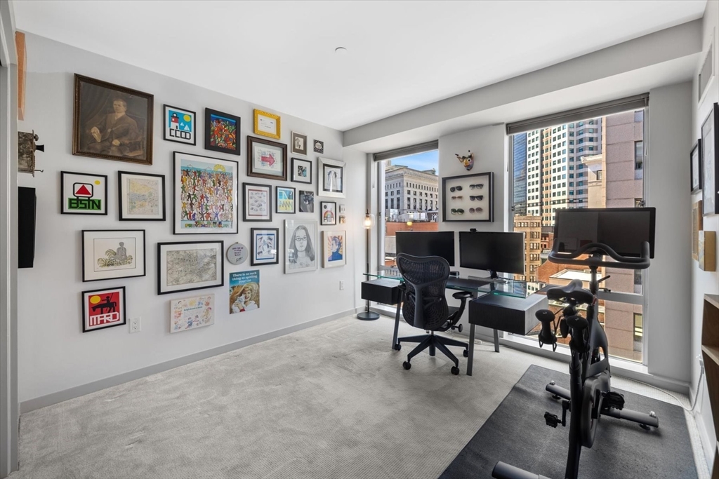 80 Broad Street, Unit 808 Boston, MA 02110 - Photo 20 of 27 a view of a livingroom with workspace and a couch