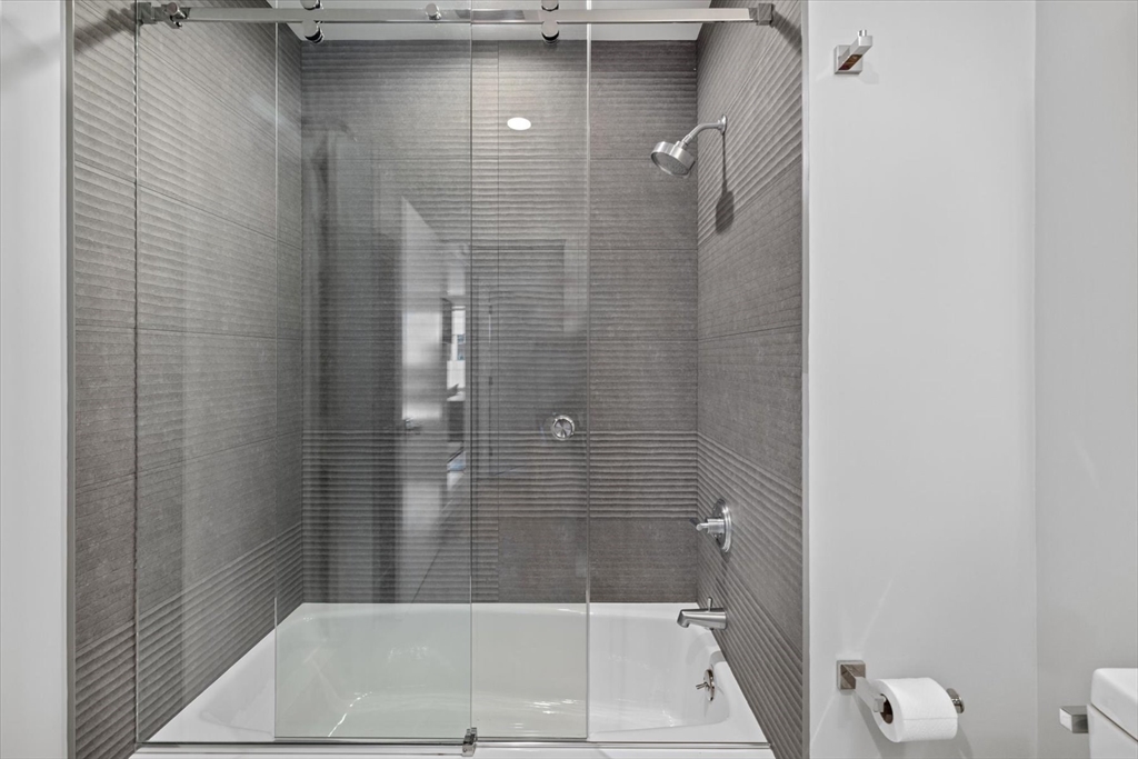 80 Broad Street, Unit 808 Boston, MA 02110 - Photo 21 of 27 a bathroom with a shower and toilet