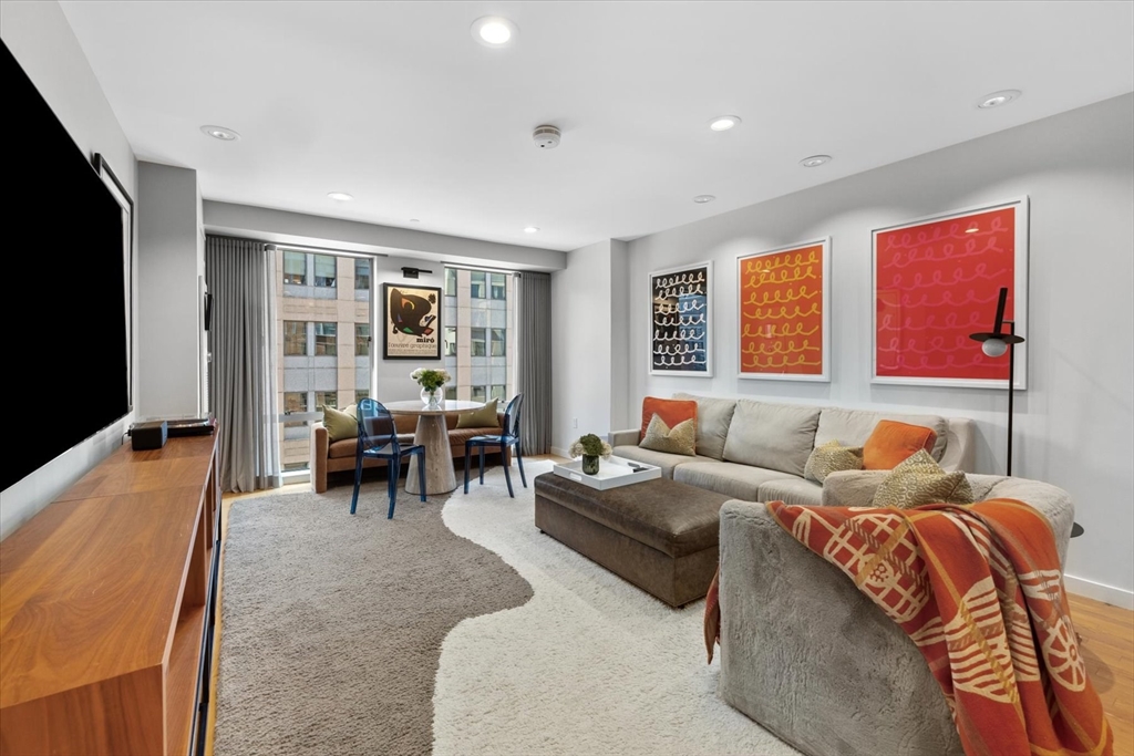 80 Broad Street, Unit 808 Boston, MA 02110 - Photo 4 of 27 a living room with furniture and large windows