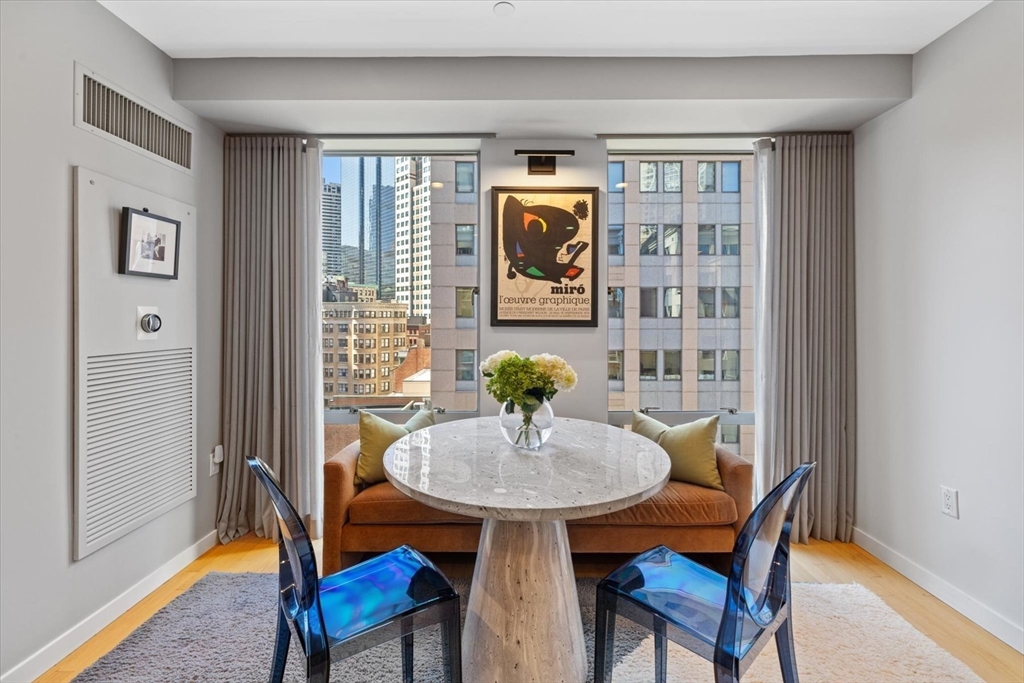 80 Broad Street, Unit 808 Boston, MA 02110 - Photo 9 of 27 a view of a dining room with furniture window and wooden floor