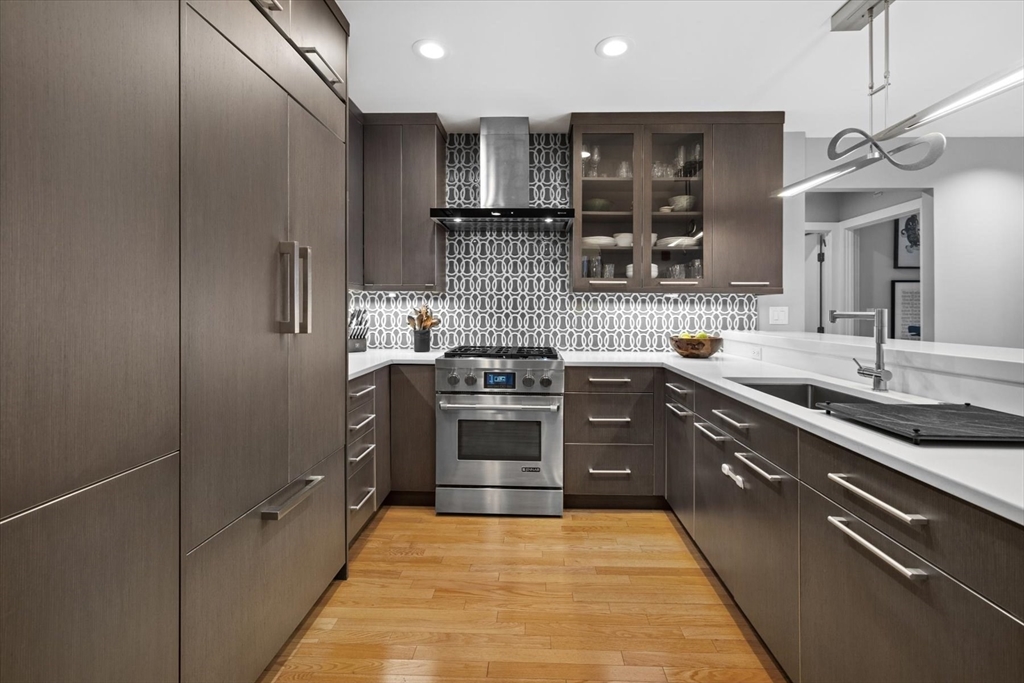 80 Broad Street, Unit 808 Boston, MA 02110 - Photo 10 of 27 a kitchen with stainless steel appliances granite countertop a sink and stove