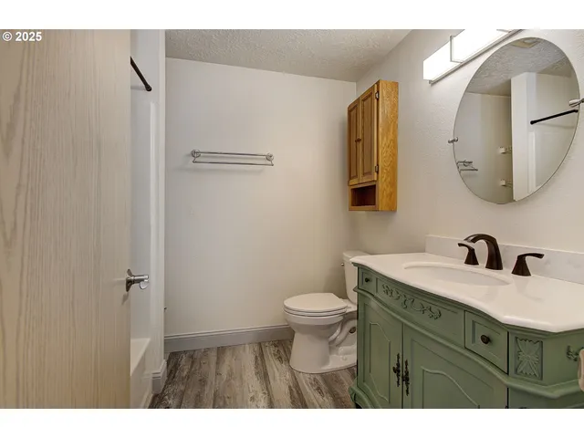 a bathroom with a sink vanity mirror and toilet