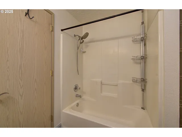 a bathroom with a shower and a bath tub