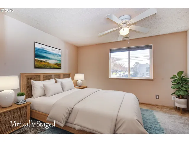 a bedroom with a bed and a painting on the wall
