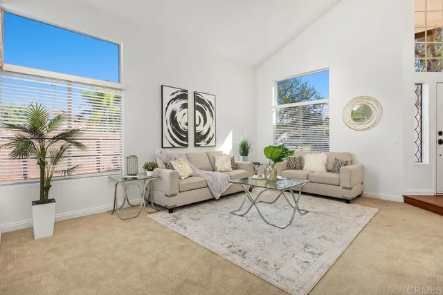 a living room with furniture and flowers