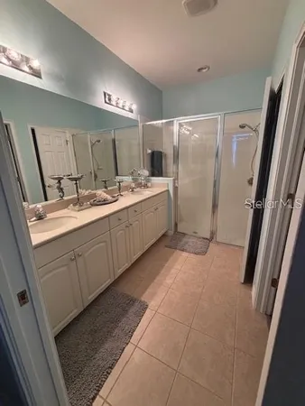 a bathroom with a double vanity sink and mirror