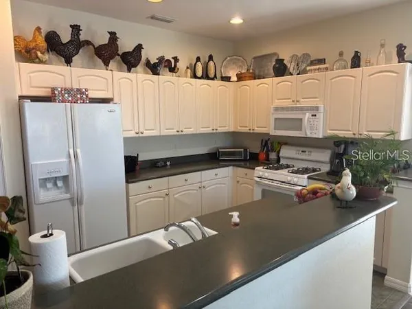 a view of a kitchen with appliances and cabinets