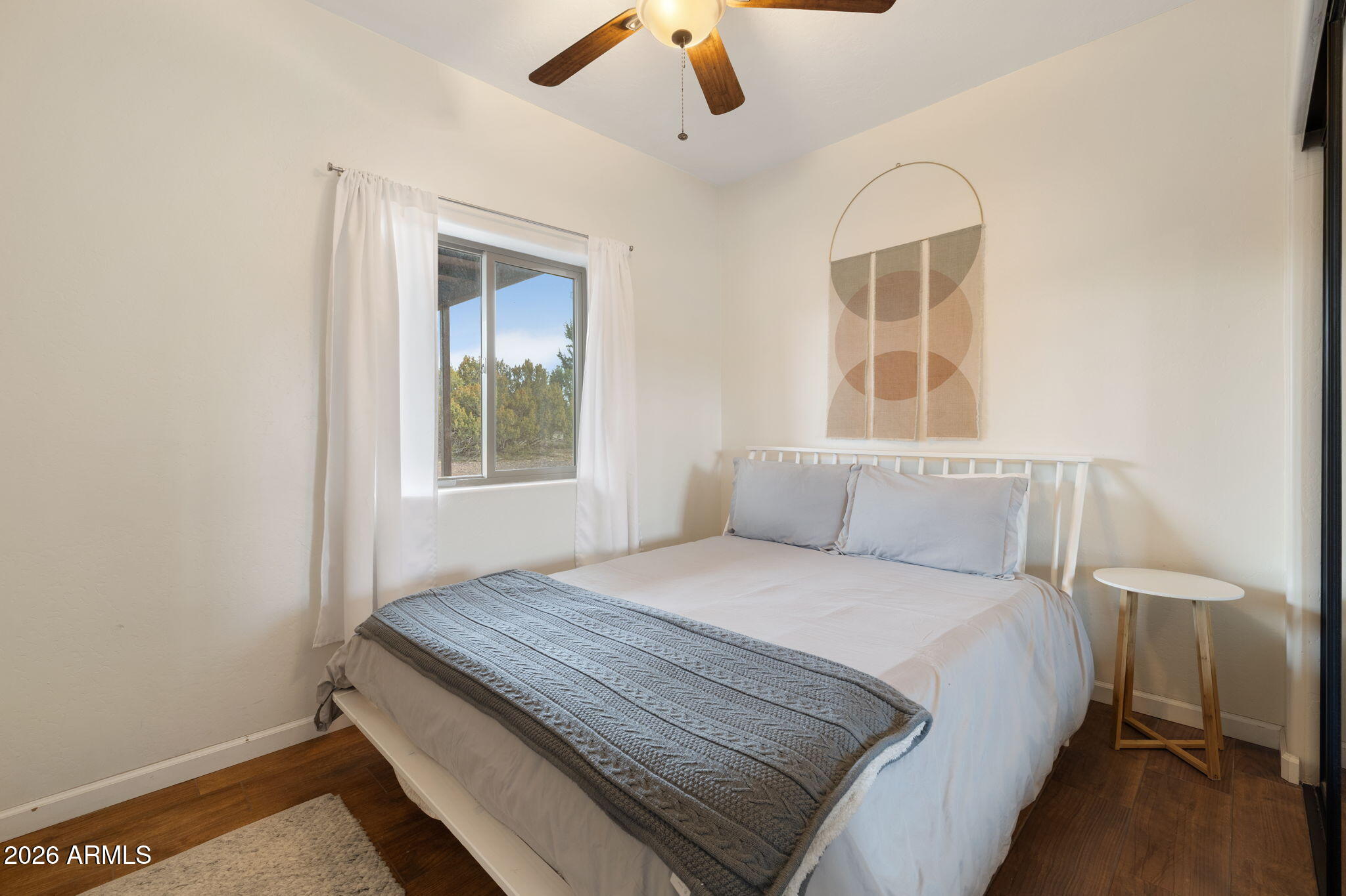 9042 North Red Fox Lane Williams, AZ 86046 - Photo 14 of 56 a bedroom with a bed and a window