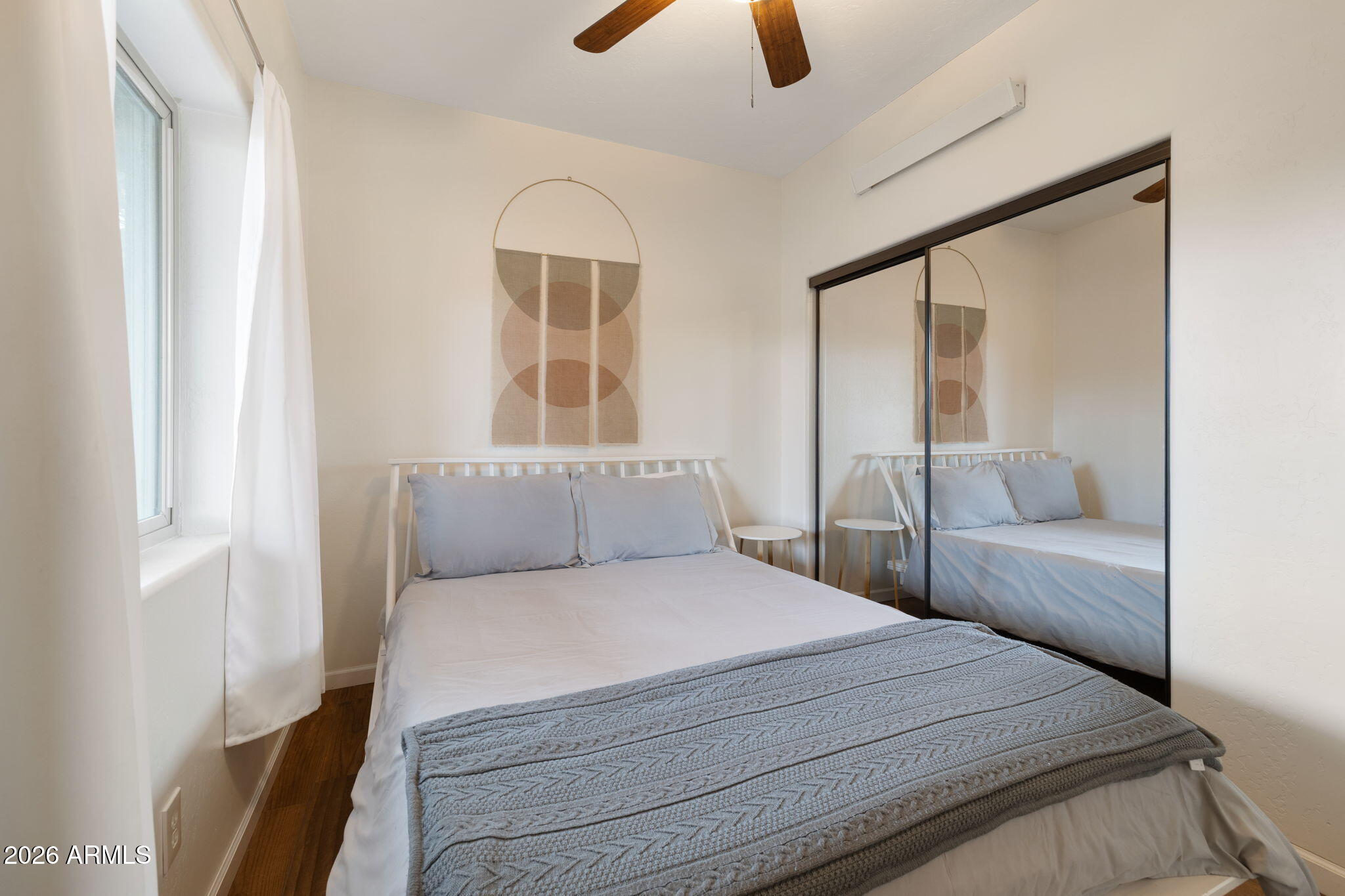 9042 North Red Fox Lane Williams, AZ 86046 - Photo 15 of 56 a bedroom with a large bed and a large window