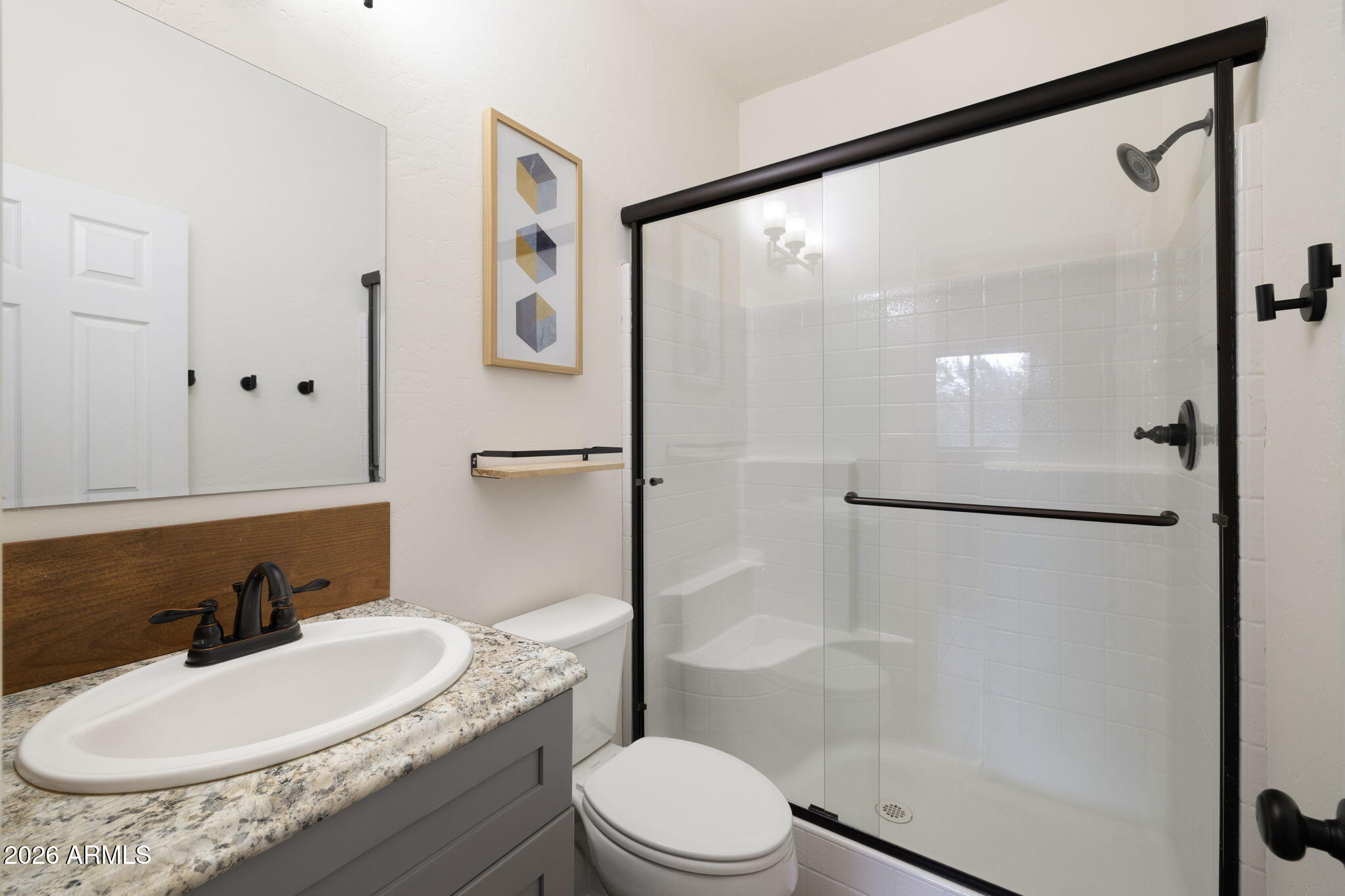 9042 North Red Fox Lane Williams, AZ 86046 - Photo 16 of 56 a bathroom with a sink a toilet and a mirror