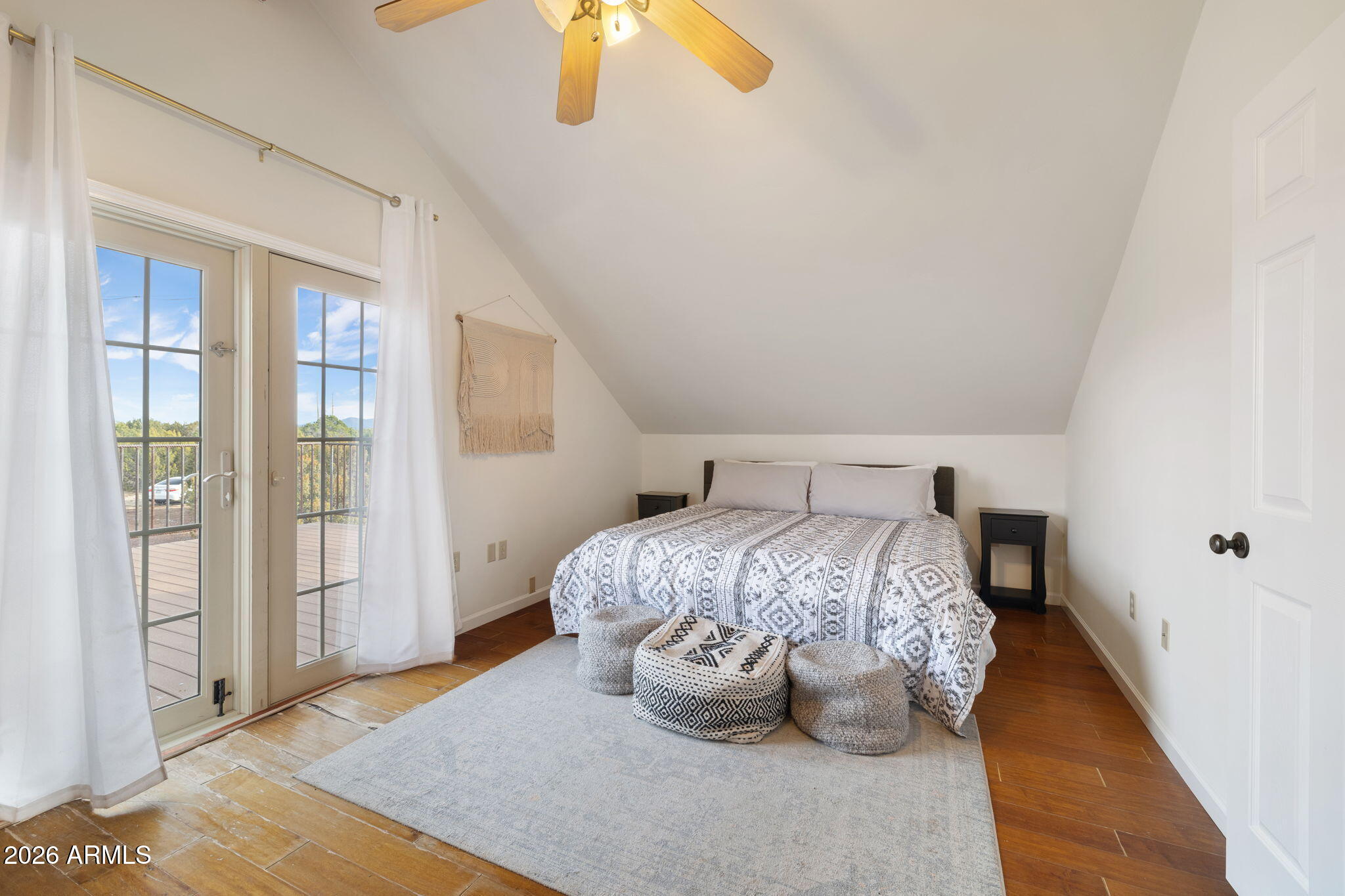 9042 North Red Fox Lane Williams, AZ 86046 - Photo 35 of 56 a bedroom with a bed and wooden floor