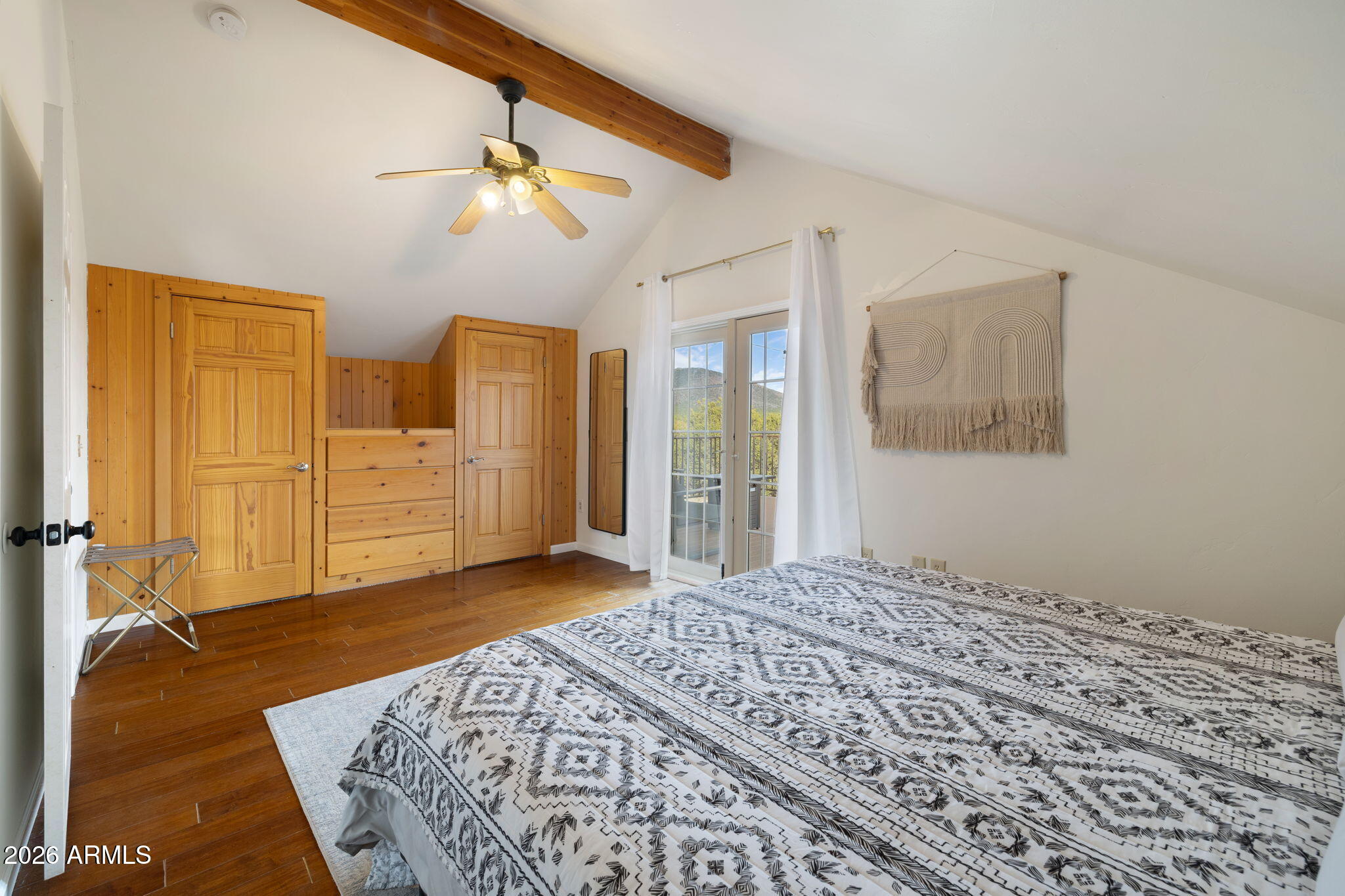 9042 North Red Fox Lane Williams, AZ 86046 - Photo 36 of 56 a bedroom with a bed and a chandelier