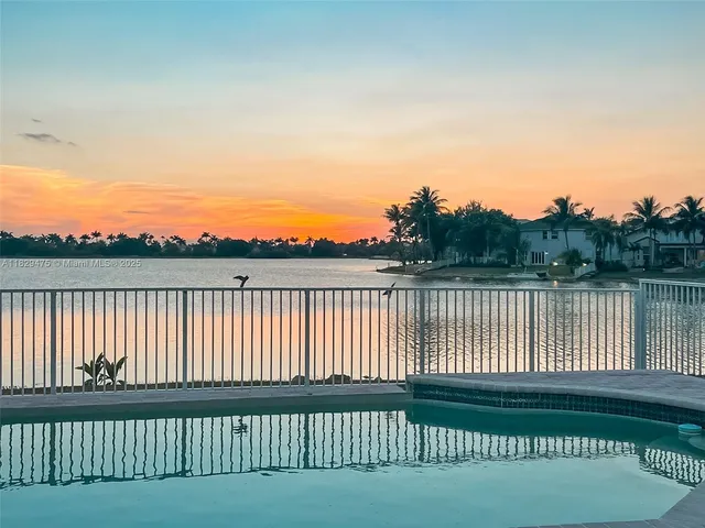 a view of a house with backyard and a tree