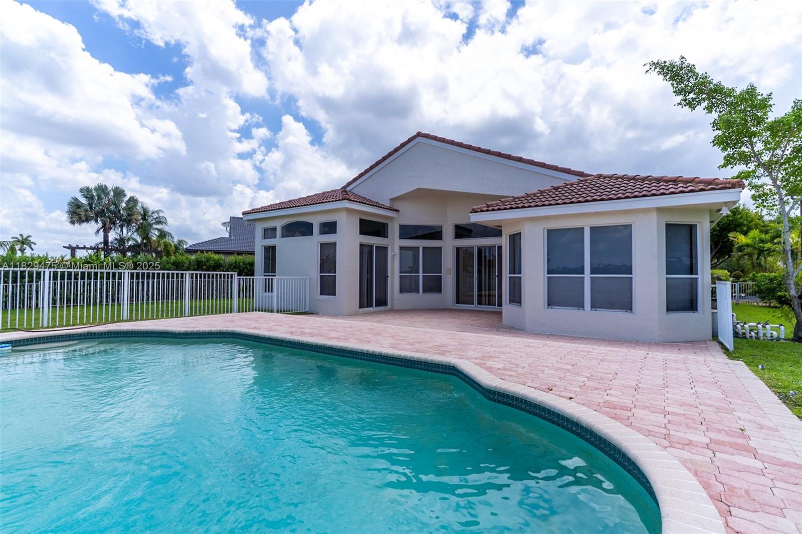 17999 Southwest 35th Street Miramar, FL 33029 - Photo 3 of 14 a front view of a house with garden