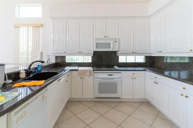 a view of a dining room with furniture wooden floor and chandelier