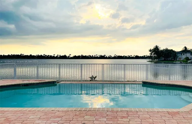 a view of a house with a swimming pool and a yard