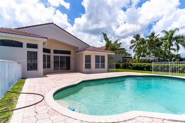 a view of swimming pool is middle in middle of the house