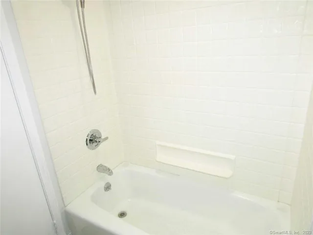 a bathroom with a white bathtub