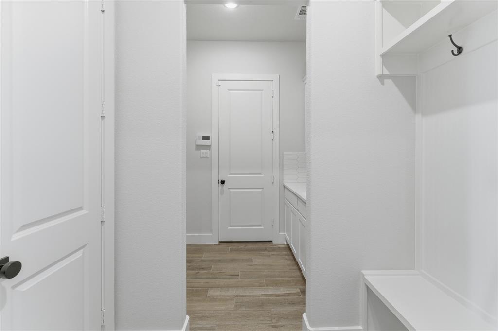 814 Vly Rdg Road Van Alstyne, TX 75495 - Photo 9 of 24 a view of a hallway with wooden floor and closet
