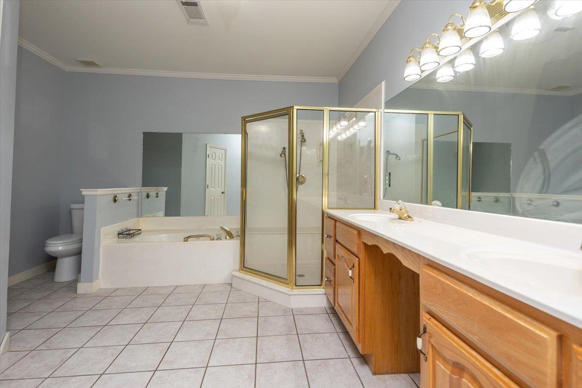 346 Beaver Road Munford, TN 38058 - Photo 15 of 24 MASTER bathroom featuring crown molding, toilet, and tile patterned flooring