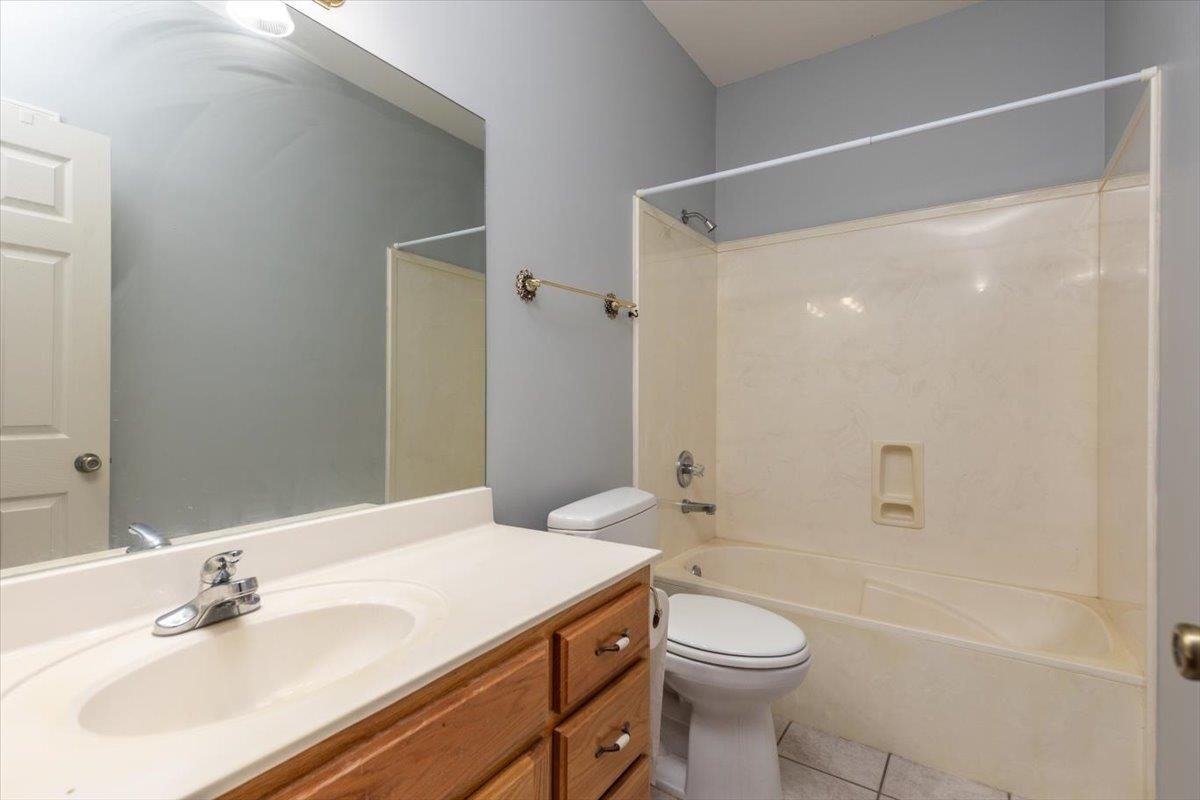 346 Beaver Road Munford, TN 38058 - Photo 18 of 24 Full bathroom with toilet, shower combination, tile patterned flooring, and vanity
