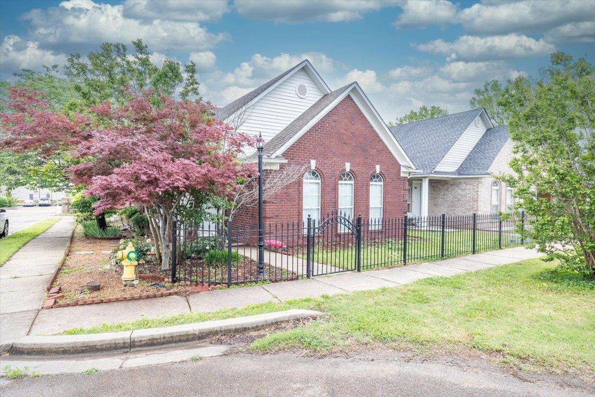 346 Beaver Road Munford, TN 38058 - Photo 2 of 24 View of front facade featuring fence private yard, roof with shingles, a front lawn, and brick siding