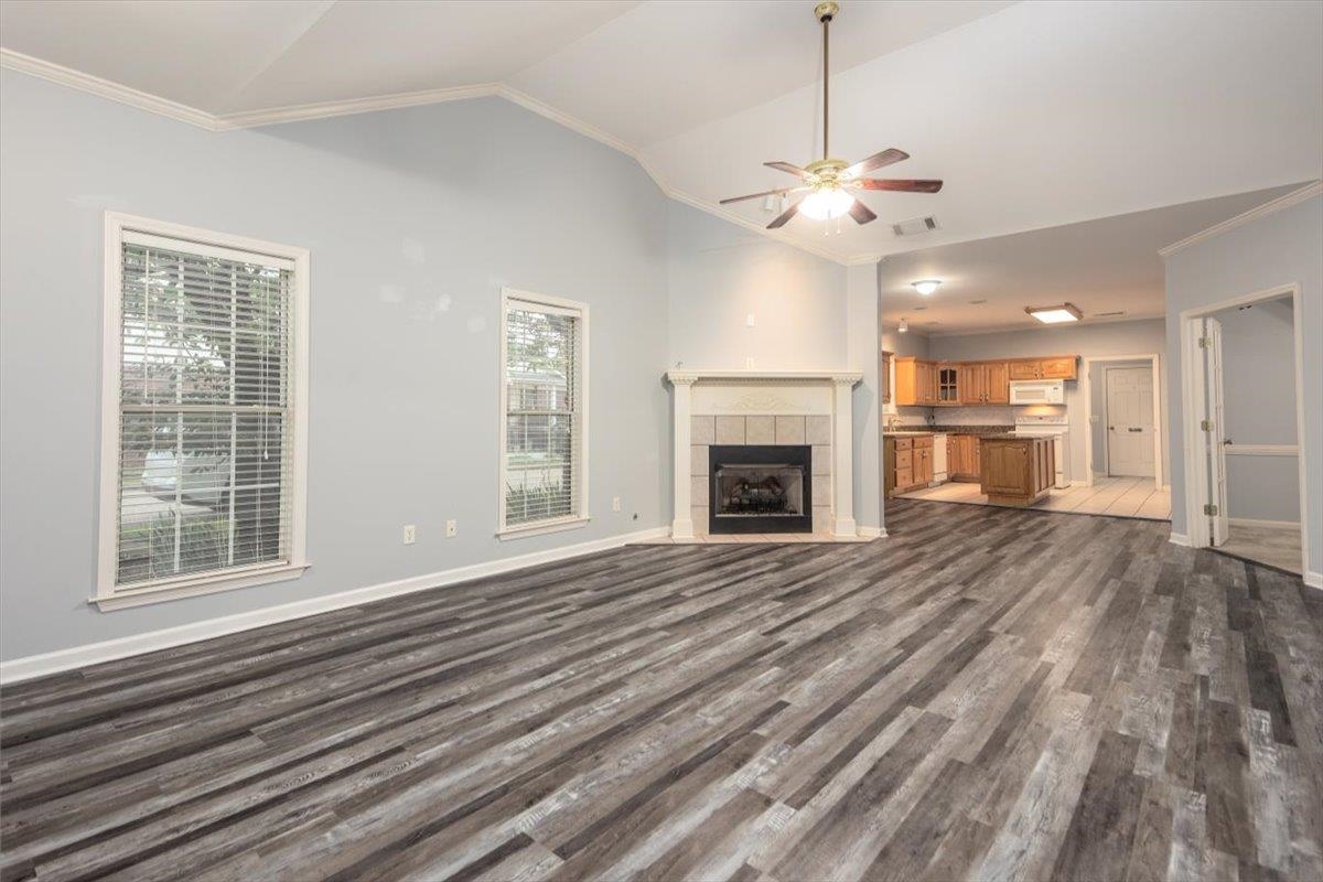 346 Beaver Road Munford, TN 38058 - Photo 3 of 24 Living room with lofted ceiling, dark wood-style flooring, baseboards, and crown molding