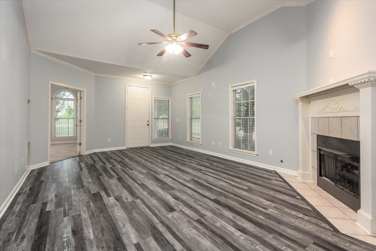 346 Beaver Road Munford, TN 38058 - Photo 4 of 24 Unfurnished living room featuring baseboards, a wealth of natural light, ceiling fan, and wood finished floors