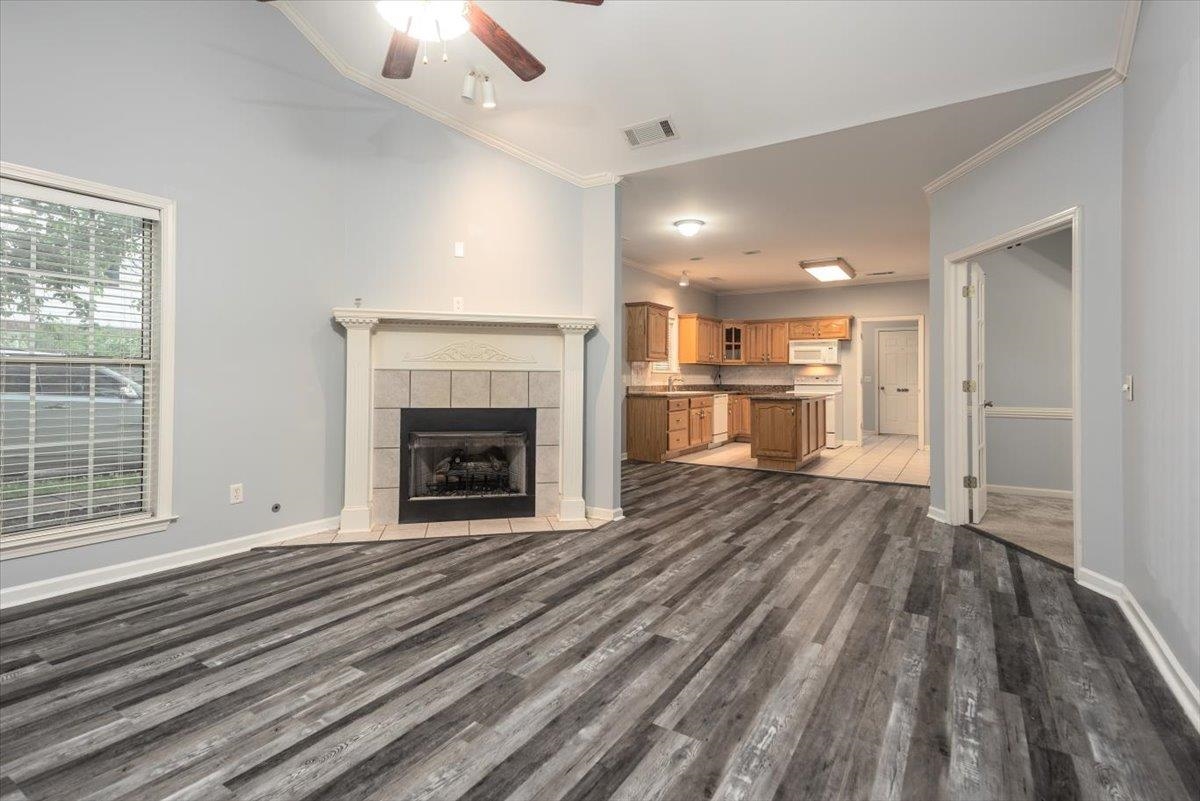 346 Beaver Road Munford, TN 38058 - Photo 5 of 24 Unfurnished living room featuring ceiling fan, crown molding, visible vents, and wood finished floors