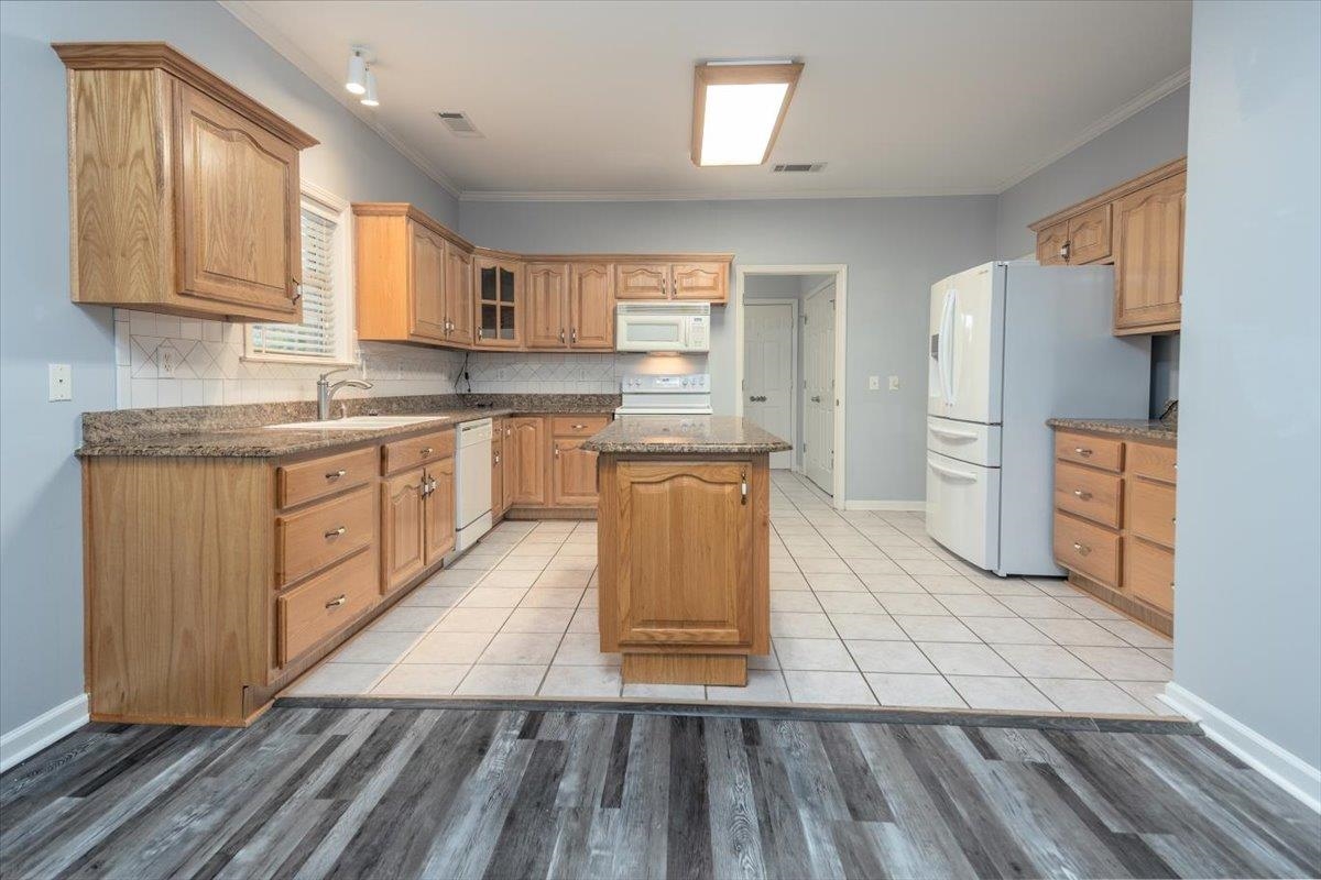 346 Beaver Road Munford, TN 38058 - Photo 8 of 24 Kitchen with a sink, white appliances, ornamental molding, visible vents, and a kitchen island