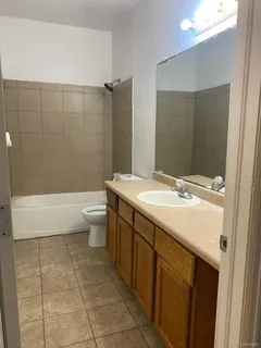 a bathroom with a double vanity sink toilet and shower