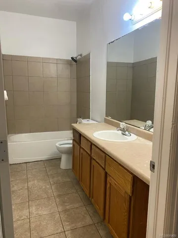 a bathroom with a double vanity sink toilet and shower