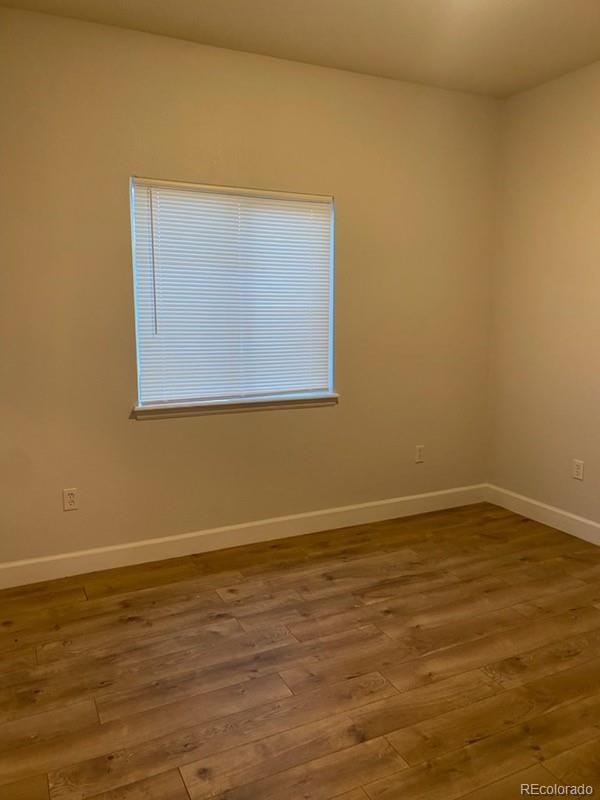 4580 West Alameda Avenue Denver, CO 80219 - Photo 17 of 18 a view of an empty room with wooden floor