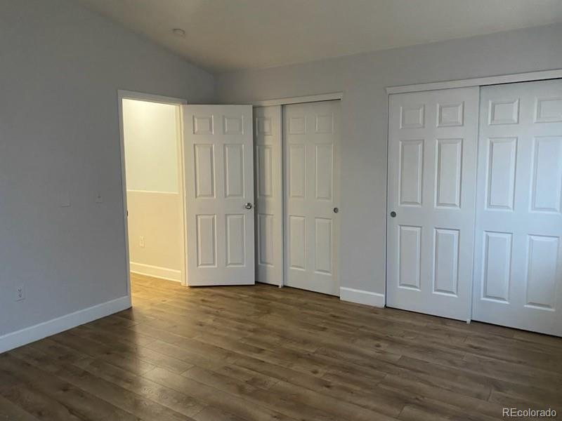 4580 West Alameda Avenue Denver, CO 80219 - Photo 6 of 18 a view of an empty room with wooden floor