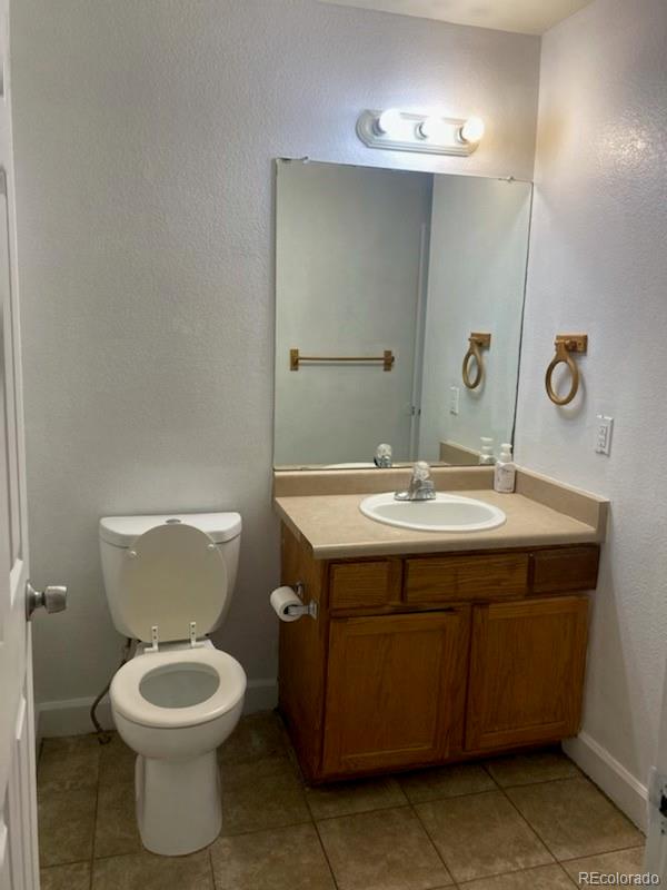 4580 West Alameda Avenue Denver, CO 80219 - Photo 7 of 18 a bathroom with a toilet sink and mirror