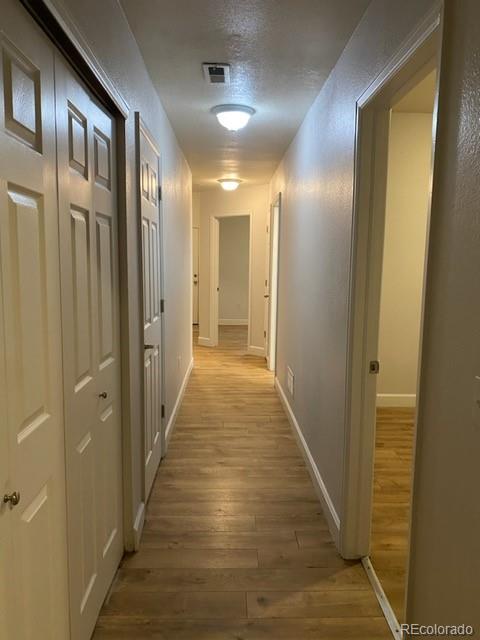 4580 West Alameda Avenue Denver, CO 80219 - Photo 10 of 18 a view of hallway with wooden floor