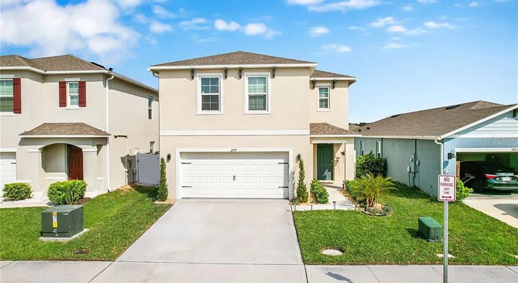 a front view of a house with a yard and garage