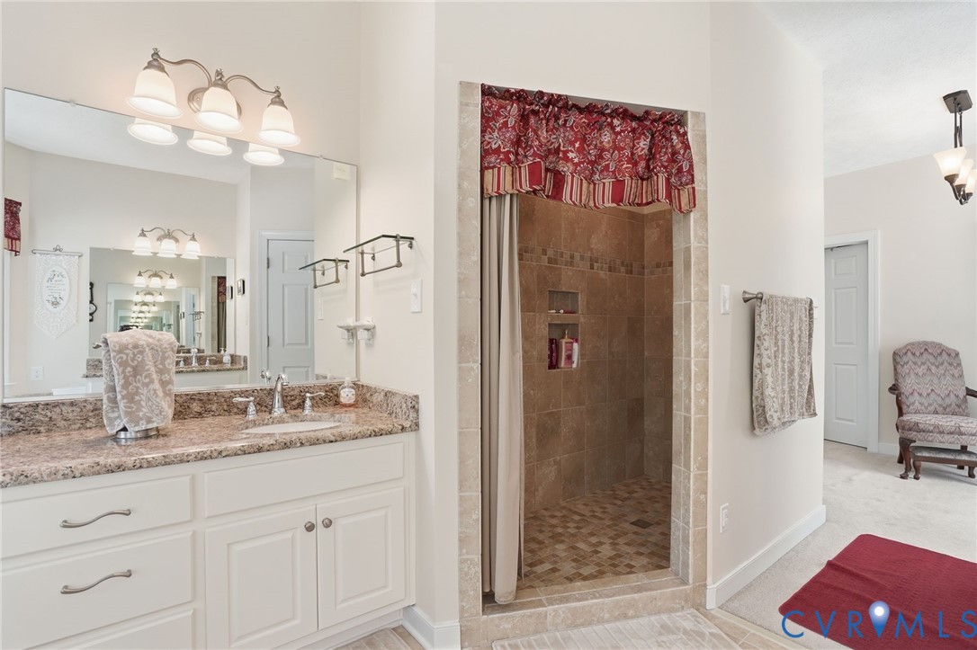 3600 Market Road Mechanicsville, VA 23111 - Photo 32 of 67 a en suite bathroom with a granite countertop sink mirror and shower