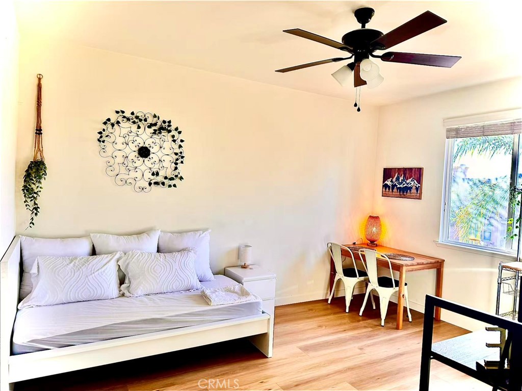 6805 Edinburgh Road Eastvale, CA 92880 - Photo 11 of 47 a living room with furniture and a wooden floor