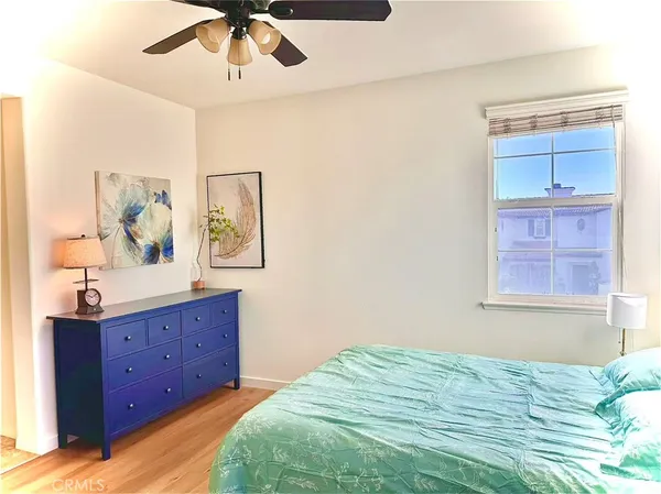 a bedroom with a bed lamp and a window