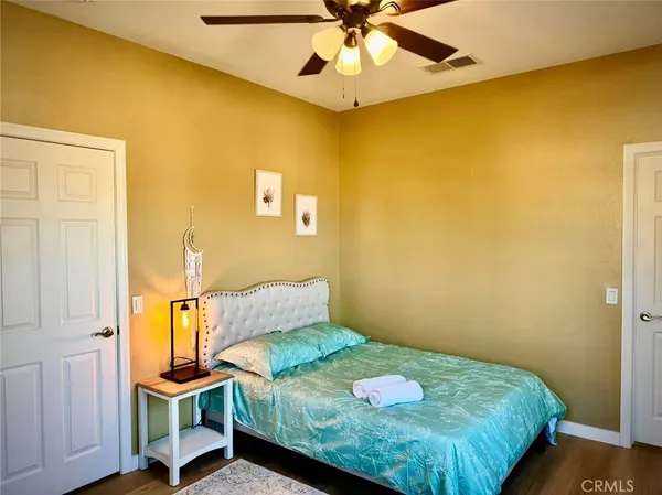 a bedroom with a bed and a painting on the wall